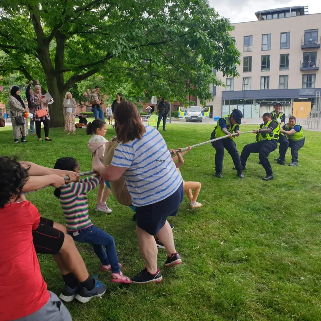 kids playing tug of war with the police at castleward liversage square park community day Derbyshire neighbourhood watch